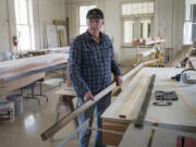 Jim Bunzey, in the Fort Vancouver National Trust workshop, prepares a length of salvaged cedar to be used to renovate a weathered park bench.