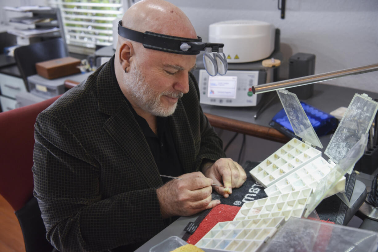 Lloyd Kimeldorf layers a molar with dry powder at Vulcan Laboratory in Vancouver on April 19.