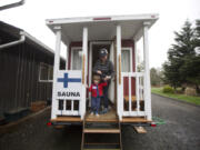 Oliver Murray and his mother, Marita Ghobrial, exit the Traveling Sauna, which made a stop in Battle Ground on Saturday.