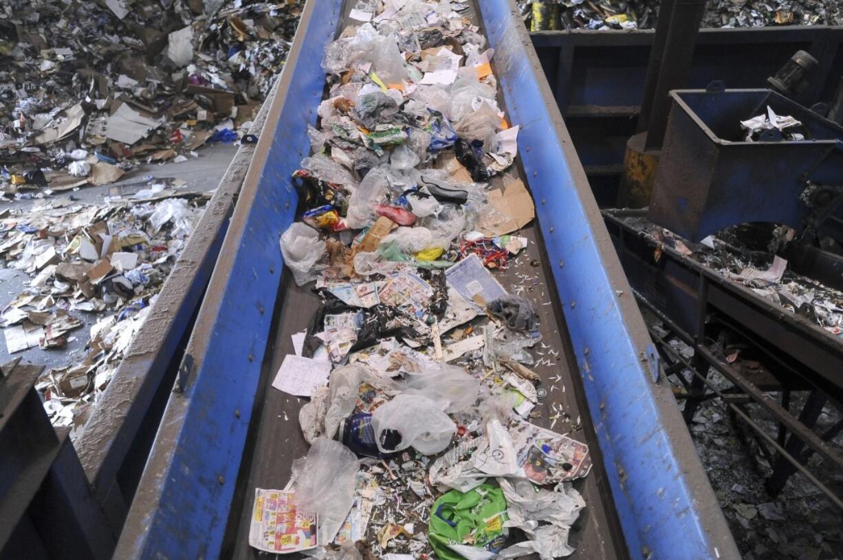 A steady stream of plastic bags and plastic film that residents mistakenly deposited in recycling carts is carried by conveyor to the trash at the West Van Material Recovery Facility in 2015. The bags and film aren't accepted at the recycling facility because they get tangled in the sorting machinery.