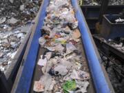 A steady stream of plastic bags and plastic film that residents mistakenly deposited in recycling carts is carried by conveyor to the trash at the West Van Material Recovery Facility in 2015. The bags and film aren't accepted at the recycling facility because they get tangled in the sorting machinery.