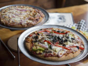 The herbivore pizza, front, is pictured next to the Sweet Baby pizza at A Beer at a Time in Camas.