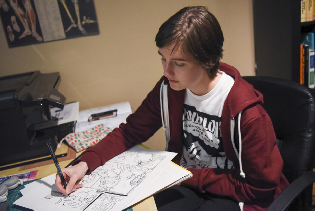 Ridgefield High School student Tatum Howlett works on a comic from her desk at her home in Battle Ground.