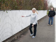 Jane Knable points to a spot on her family&#039;s backyard fence that was recently tagged with 30 feet of graffiti.