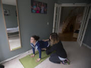 Client Cecelia Mikles, left, works with women&#039;s health physical therapist Christina Trautman during a session Wednesday at Trautman&#039;s Felida home. Mikles is 23 weeks pregnant and is going through Trautman&#039;s Pregnancy and Postpartum Exercise Training program to stay fit during pregnancy and prepare for labor.