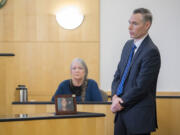 Deputy Prosecutor James Smith, right, speaks to the jury while displaying a framed photo of victim Brandon Maulding as his mother, Linda, background, testifies during Stephen Reichow&#039;s murder trial Thursday in Clark County Superior Court. Reichow is accused of beating Maulding to death with a baseball bat in August 2015 in Battle Ground.