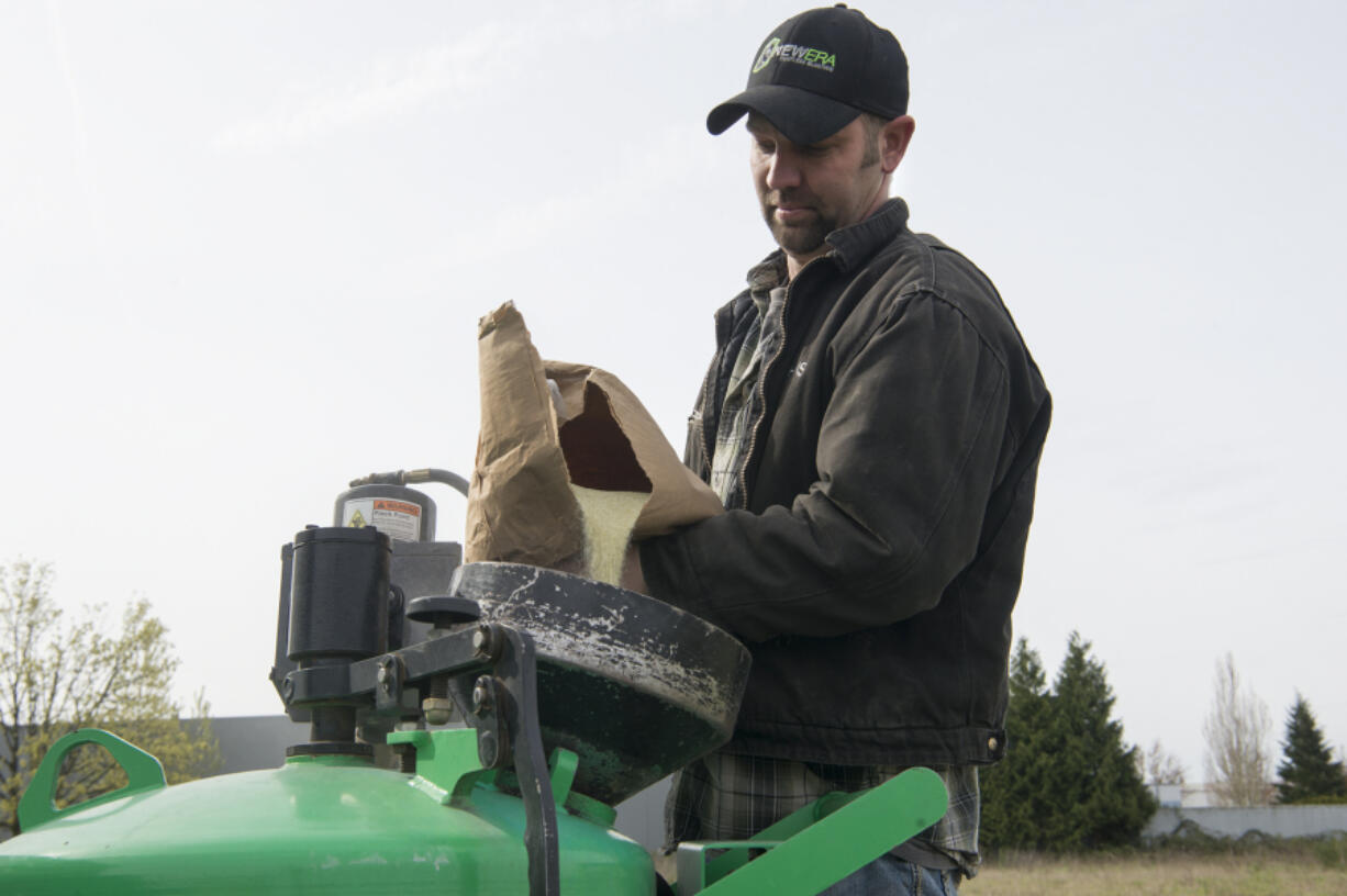 Chris Wallschlaeger pours finely crushed bottle glass into a sandblast pot at New Era Sandblasting in Vancouver. All blasting materials used at New Era are &quot;green&quot; and silica-free, according to Wallschlaeger.