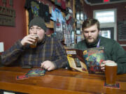 Jake Storgaard, left, takes a sip of the Shadow Shinobi IPA while Sky Cumlander reads the Shadow Shinobi comic book at Loowit Brewing Co. The brewery released the comic book to announce the rebranding of its most popular beer after a copyright dispute.