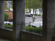 A man leaves the county&#039;s parking structure early in the morning before most employees arrive. Vancouver allows limited camping on public property, which includes the county building. The situation has created tension between county employees and homeless camped out in the structure. (Photos by Randy L.