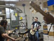 Brian Tashima practices with his band, Second Player Score, at his home in east Vancouver on a recent Sunday. Second Player Score will appear during a book launch and benefit for Autism Empowerment on Saturday. Tashima is the author of a series of fantasy adventures about a heroic boy - a rock musician - who is on the autism spectrum.