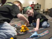 Declan Reagan, 5, right, plays with his twin brother, Adrian, during a bone marrow and blood donation event March 28 at The Nines hotel in Portland. Declan needs a lifesaving bone marrow transplant.