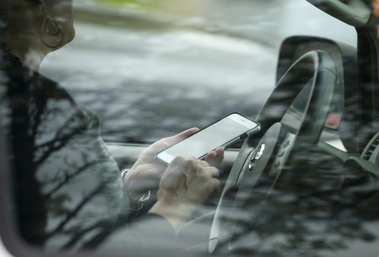 A motorist is stopped by police for talking on a cellphone while driving Wednesday in Vancouver.