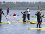 Beginning stand-up paddlers practice during a class at the 25th annual Spring Paddle Festival at Vancouver Lake Sunday. Hundreds came out over the weekend to check out boats and try their hands on the water. (Photos by Randy L.