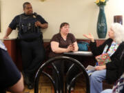 Citizens ask Vancouver police Officer McAvoy Shipp questions Tuesday at &quot;Coffee with a Cop&quot; at the McDonald&#039;s on Andresen Road in Vancouver.