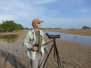 Noah Strycker scans for shorebirds near Denpasar, Bali, in 2015. That year Strycker set a world record for seeing the most birds in a single year. He spoke at an event held by the Vancouver Audubon Society.