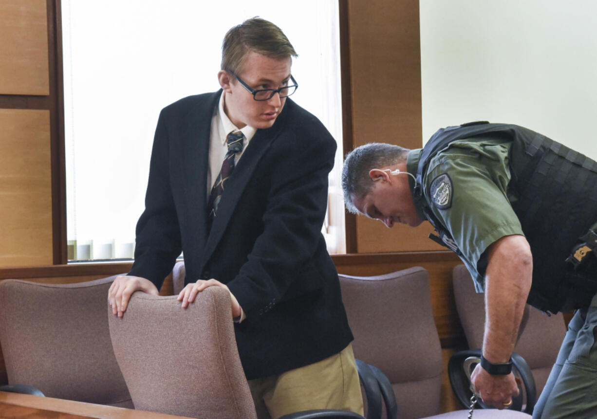 A corrections deputy removes shackles from Zachary Akers&#039; ankles before closing arguments in his child exploitation trial Thursday in Clark County Superior Court. The jury found Akers guilty on all nine counts.