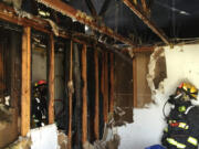 Firefighters deal with a fire that crept into a triplex&#039;s attic in east Vancouver, 903 S.E. 152nd Ave., Monday afternoon.