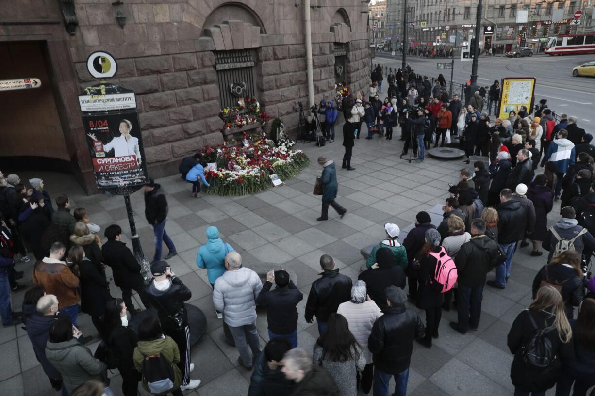 People gather at a symbolic memorial at Technologicheskiy Institute subway station in St. Petersburg, Russia, Tuesday, April 4, 2017. A bomb blast tore through a subway train deep under Russia's second-largest city St. Petersburg Monday, killing several people and wounding many more in a chaotic scene that left victims sprawled on a smoky platform.