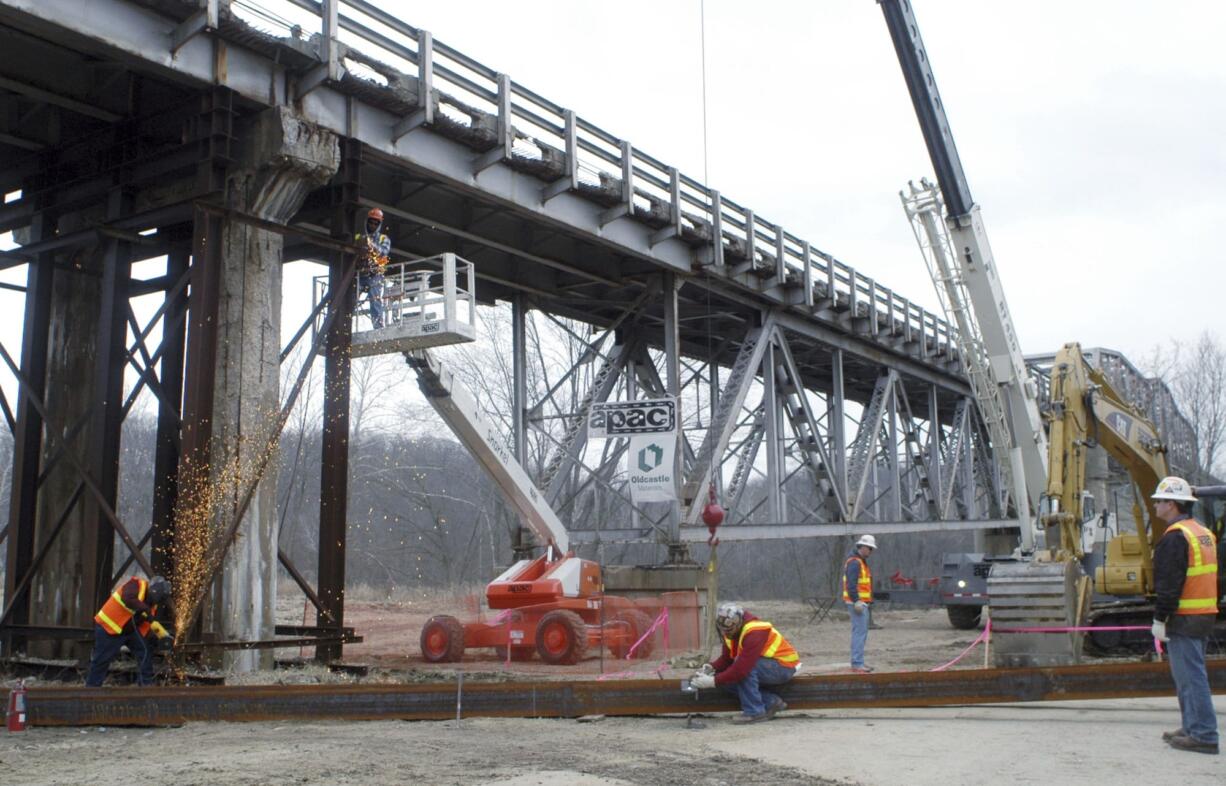 FILE - In this Feb. 17, 2009 file photo, work continues on a Missouri Department of Transportation bridge replacement project near Tuscumbia, Mo. The bridge replacement was supported by federal stimulus funds. President Donald Trump said April 4, 2017, he was unaware of anything that was built from his predecessor's stimulus package.