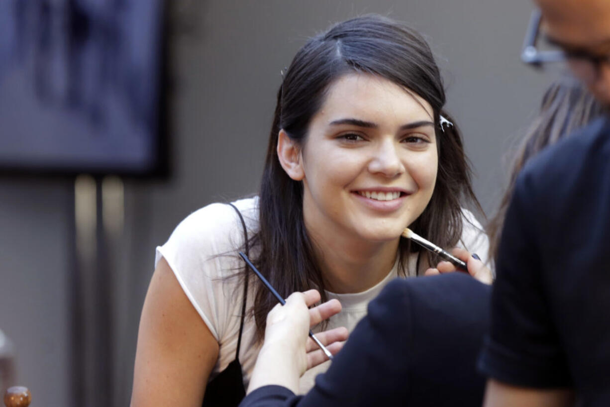 Model Kendall Jenner has makeup applied backstage before the Michael Kors Spring 2017 collection is modeled during Fashion Week, in New York. Pepsi is not saying whether it will continue to run an ad, featuring Jenner, that is being widely criticized and mocked on social media for appearing to trivialize protests for social justice causes.