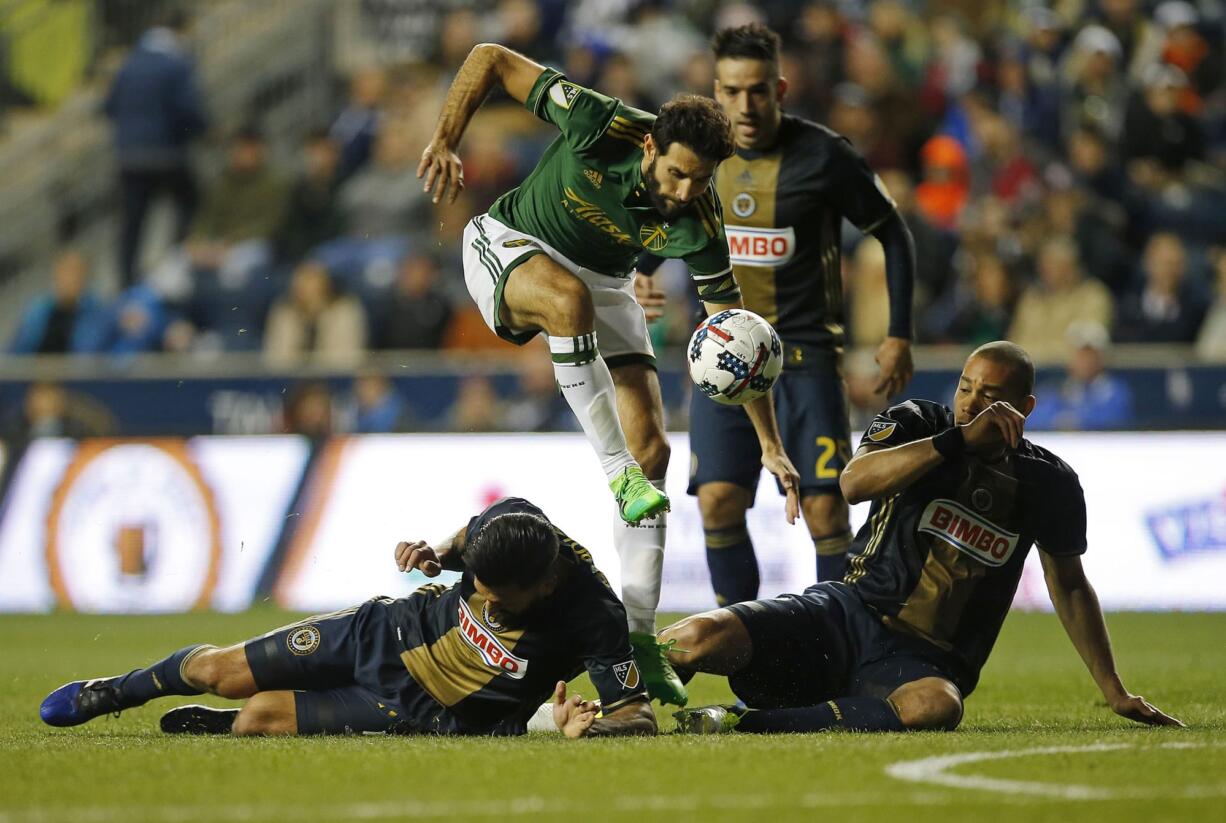 Portland Timbers midfielder Diego Valeri moves the ball past Philadelphia Union defenders Richie Marquez and Oguchi Onyewu during the first half at Chester, Pa., on Saturday, April 8, 2017.