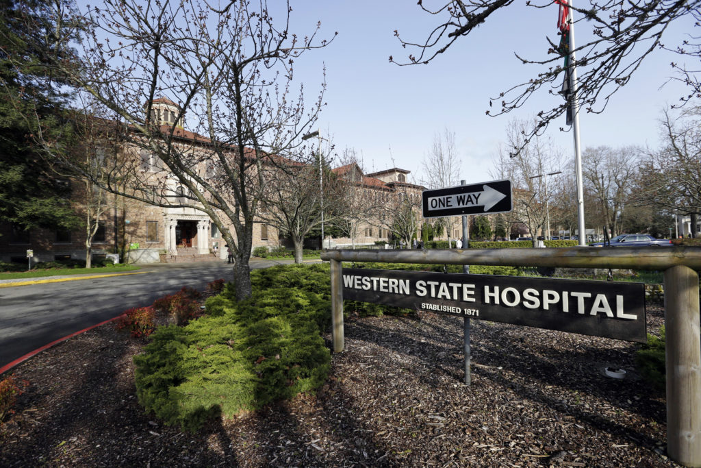 A sign sits by the entrance to Western State Hospital on Tuesday, April 11, 2017, in Lakewood, Wash. Gov. Jay Inslee spoke with media members Tuesday after touring the state's largest psychiatric hospital to get an update on its efforts to address safety problems that got it into trouble with federal regulators. Western State Hospital is at risk of losing millions in federal funds over health and safety violations that were discovered last year.