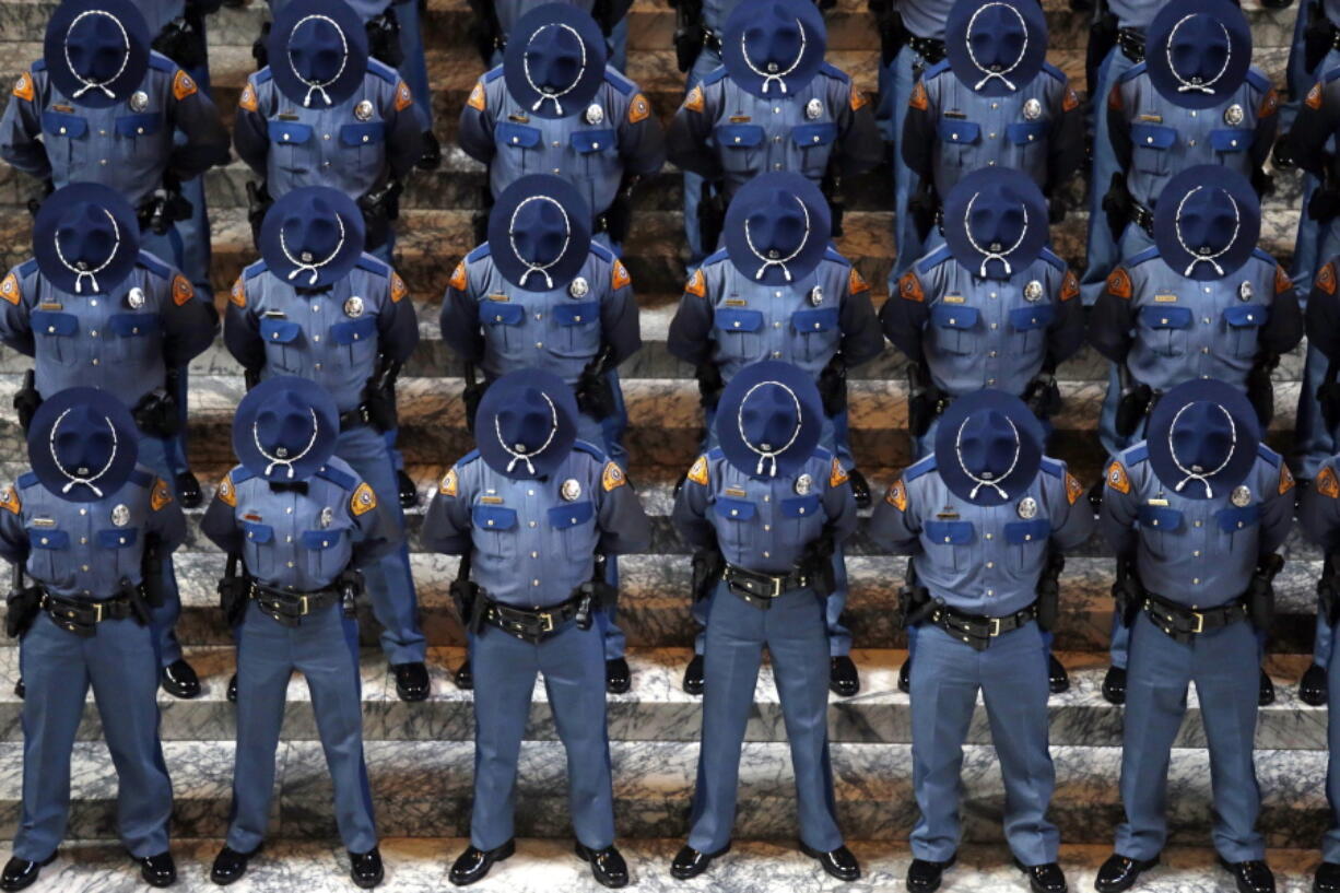 New Washington State Patrol troopers bow their heads during a prayer at the Patrol&#039;s graduation ceremonies in the Capitol rotunda, Wednesday, April 26, 2017, in Olympia, Wash. The 49 graduates of the 107th Trooper Basic Training Class went through nearly six months of field and academy training, and were given the oath of office by Washington State Supreme Court Justice Mary Fairhurst.