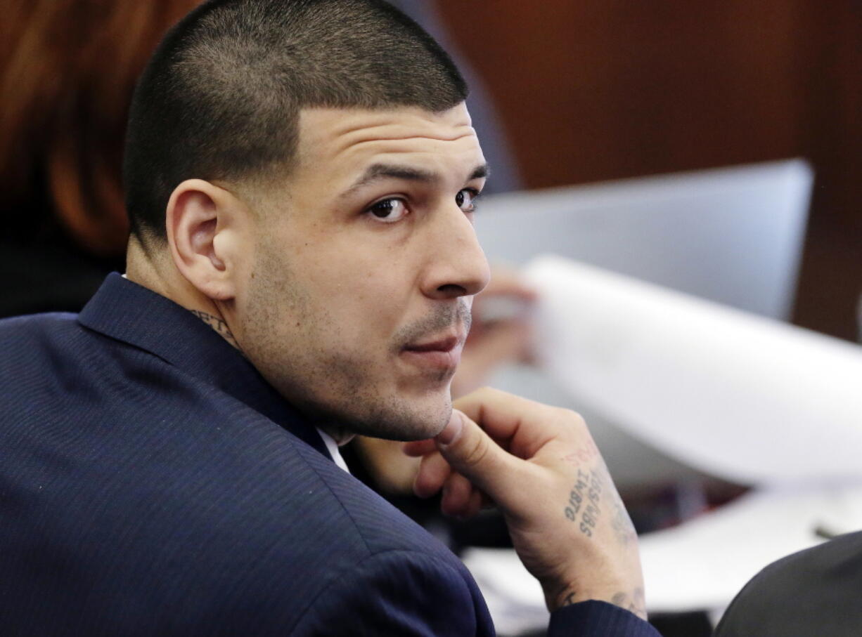 Aaron Hernandez listens March 15, 2017, during his double murder trial in Suffolk Superior Court, in Boston. Massachusetts prison officials said Hernandez hanged himself in his cell and pronounced dead at a hospital early Wednesday, April 19, 2017.