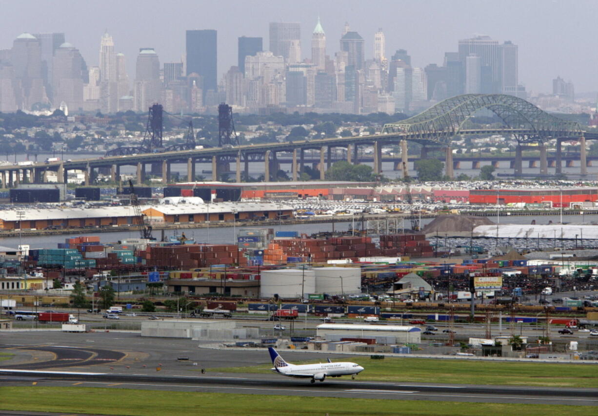 The Casicano Memorial Bridge at center and the Manhattan, New York skyline in the background as a passenger airplane lands in 2008 at Newark Liberty International Airport in Newark, N.J.