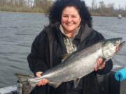 Baabs Teed of Vancouver holds a spring chinook she caught while anchor fishing in the lower Columbia River.