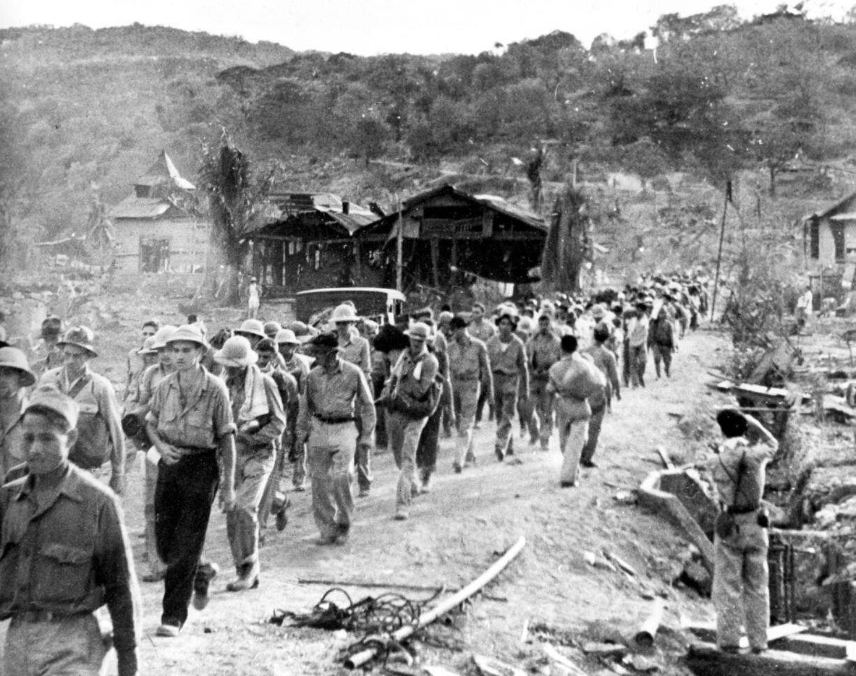 American and Filipino prisoners, captured by Japanese forces, are shown at the start of the death march near Mariveles, Philippines, after the surrender of Bataan on April 9, 1942.