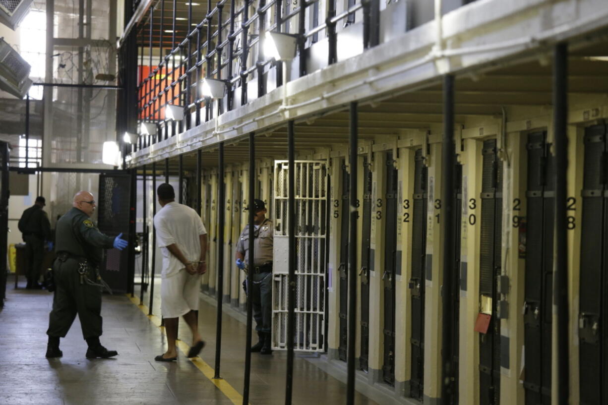 A condemned inmate is led out of his east block cell on death row Aug. 16 at San Quentin State Prison, in San Quentin, Calif. California corrections officials expect to meet a Wednesday deadline to submit revised lethal injection rules to state regulators.