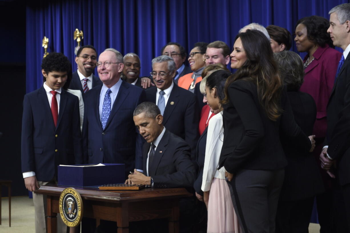 President Barack Obama signs the &quot;Every Student Succeeds Act,&quot; a major education law setting U.S. public schools on a new course of accountability, in Washington.