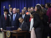 President Barack Obama signs the &quot;Every Student Succeeds Act,&quot; a major education law setting U.S. public schools on a new course of accountability, in Washington.