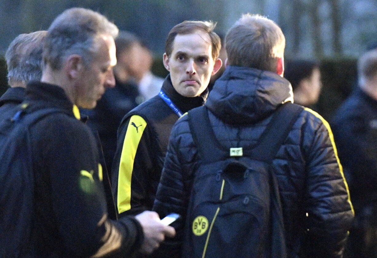 Dortmund head coach Thomas Tuchel stands outside the team bus April 11, 2017, after it was damaged in an explosion before the Champions League quarterfinal soccer match between Borussia Dortmund and AS Monaco in Dortmund, western Germany.