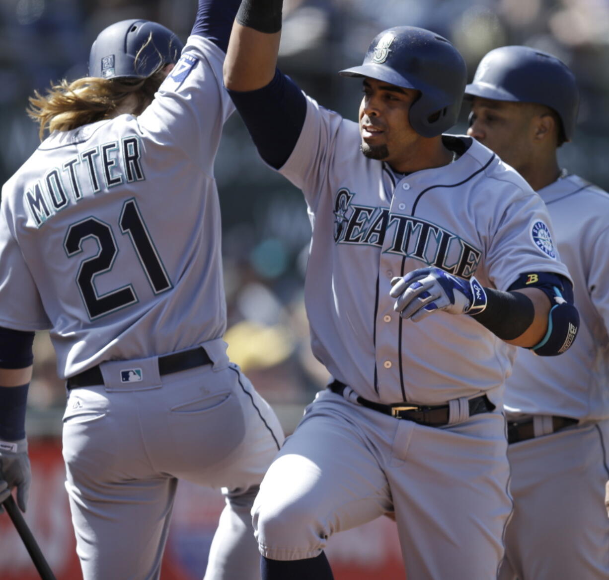 Nelson Cruz, right, celebrates with Taylor Motter (21) after hitting a three run home run in the seventh inning of Seattle&#039;s win in Oakland.