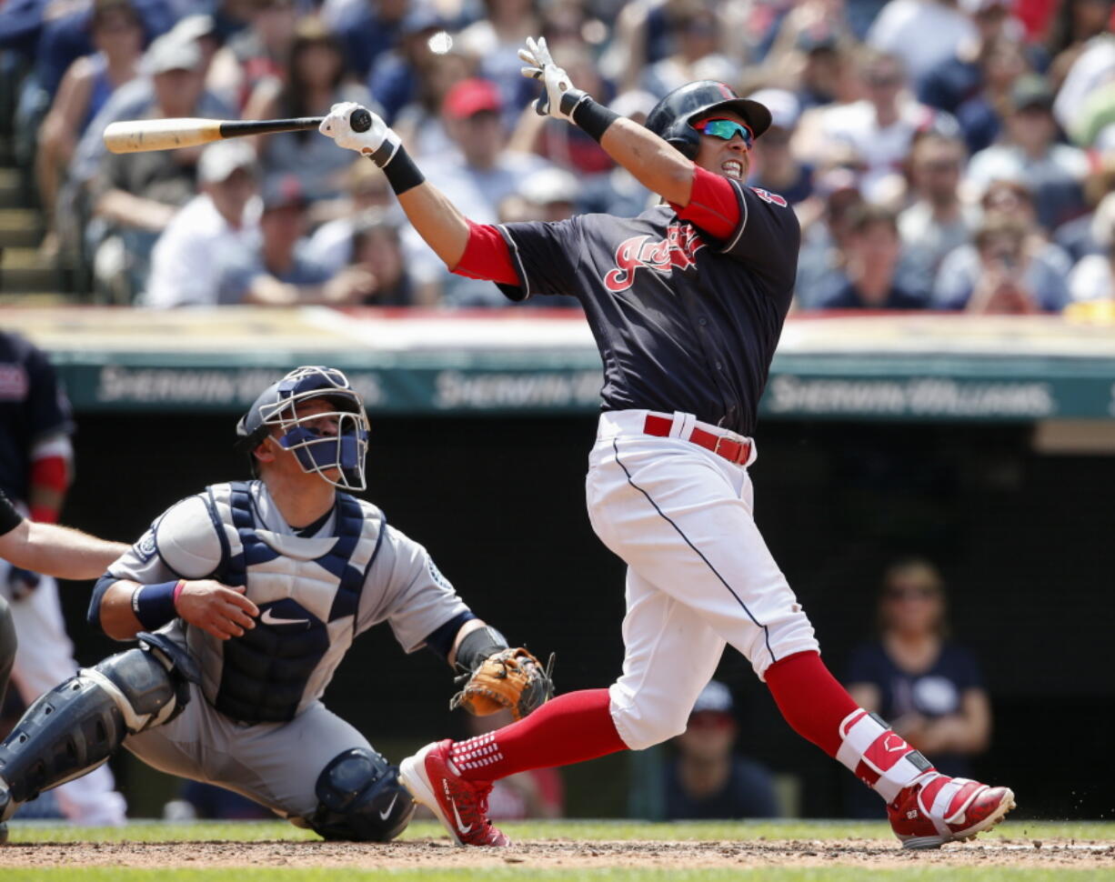 Cleveland Indians&#039; Michael Brantley watches his two-run home run as Seattle Mariners catcher Carlos Ruiz looks on during the third inning in a baseball game, Sunday, April 30, 2017, in Cleveland.