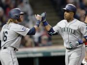 Seattle Mariners' Robinson Cano, right, is congratulated by Ben Gamel after Cano hit a two-run home run off Cleveland Indians starting pitcher Carlos Carrasco during the fourth inning of a baseball game, Friday, April 28, 2017, in Cleveland. Gamel scored on the play.