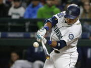 Robinson Cano hits a run-scoring double in the fourth inning against the Miami Marlins to score Jarrod Dyson on Monday. Cano was 2 for 4 with a first-inning home run as the Mariners won their fourth game in a row. (Ted S.