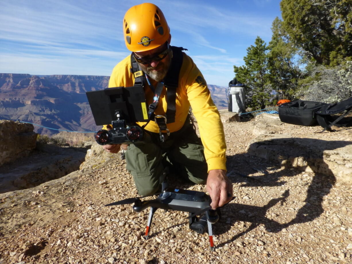 In these undated photos from 2016, a Grand Canyon National Park employee operates a drone at the park. The Grand Canyon is the only national park with its own fleet of unmanned aircraft for reaching people who have gotten lost, injured or killed. Under a program that began last fall, it has five drones and four operators.