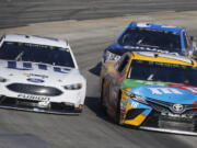 Brad Keselowski (2) and Kyle Busch (18) battle for position in Turn 4 during the NASCAR Cup Series auto race at Martinsville Speedway in Martinsville, Va., Sunday, April 2, 2017. Keselowski won the race.