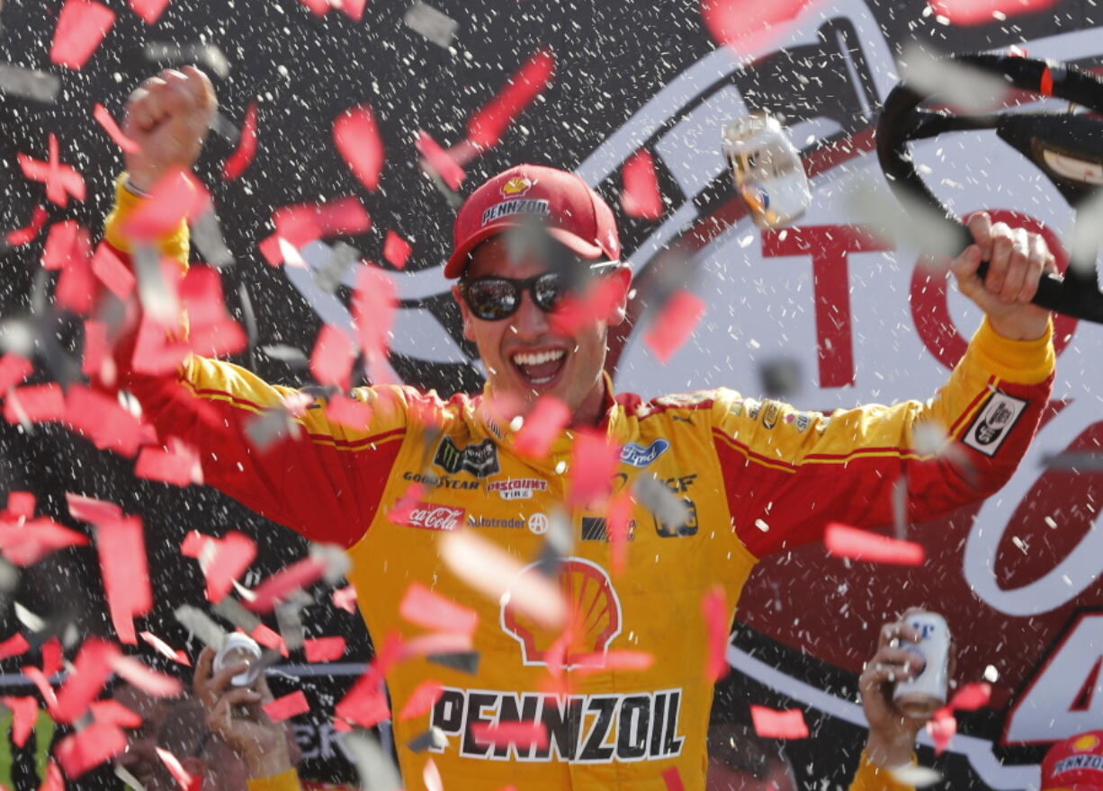 Joey Logano celebrates after winning the NASCAR Cup Series auto race in Victory Lane at Richmond International Raceway in Richmond, Va., Sunday, April 30, 2017.