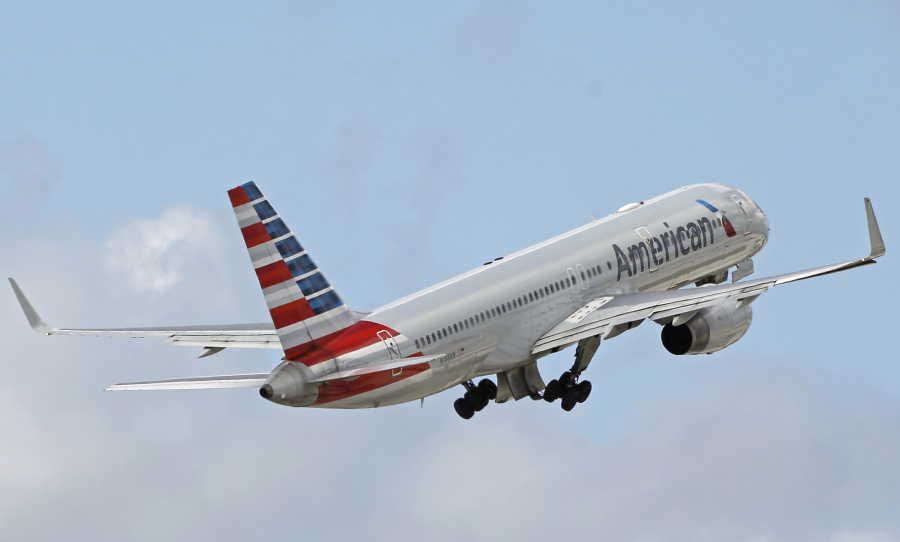 FILE - In this Friday, June 3, 2016 file photo, an American Airlines passenger jet takes off from Miami International Airport in Miami. The company said it grounded a flight attendant who got into a verbal confrontation with a passenger after taking a baby stroller away from another passenger on a Friday, April 21, 2017 flight from San Francisco to Dallas-Fort Worth.