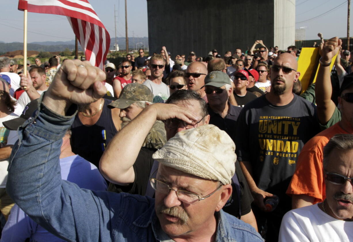 Union workers block a train headed to a port grain terminal in Longview on Sept. 7, 2011. Dockworkers were given the chance Friday to vote on a new contract extension that could provide long-term labor peace at West Coast seaports, where in recent years work slowdowns and strikes have affected billions of dollars in cargo.