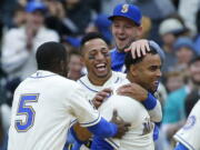 Seattle Mariners&#039; Nelson Cruz, right, is greeted by teammates including Leonys Martin, second from left, and Guillermo Heredia (5) after Cruz hit a walk-off single in the ninth inning to score Mariners&#039; Mike Freeman and give the Mariners a 8-7 win over the Texas Rangers, Sunday, April 16, 2017, in Seattle. (AP Photo/Ted S.