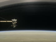 This image made available by NASA in April 2017 shows a still from the short film &quot;Cassini&#039;s Grand Finale,&quot; with the spacecraft diving between Saturn and the planet&#039;s innermost ring. Launched in 1997, Cassini reached Saturn in 2004 and has been exploring it from orbit ever since. CassiniC?Us fuel tank is almost empty, so NASA has opted for a risky, but science-rich grand finale.