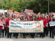 Supporters of single-payer health care march to the Capitol Wednesday in Sacramento, Calif.