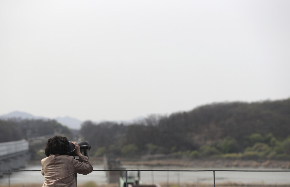 A woman uses binoculars to watch from the Imjingak Pavilion near the border village of Panmunjom, which has separated the two Koreas since the Korean War, in Paju, South Korea, Thursday, April 13, 2017. Experts say if North Korea were to attack South Korea, it would likely target Seoul&#039;s defenses with chemical and biological weapons dropped from aircraft or delivered via missiles, artillery and grenades.