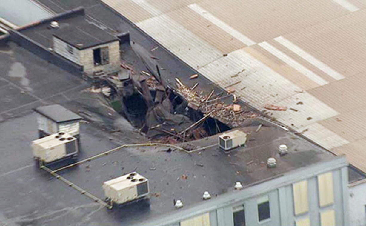 Damage to the roof of a box company in St. Louis after a boiler exploded and flew before crashing through the roof of a nearby laundry business. Authorities said several people were killed as a result of the explosion.