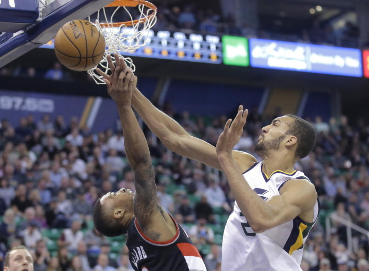 Utah Jazz center Rudy Gobert (27) blocks the shot by Portland Trail Blazers guard Damian Lillard, left, during the first half in an NBA basketball game Tuesday, April 4, 2017, in Salt Lake City.